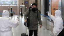 Pekerja memeriksa suhu penumpang yang tiba di Stasiun Xianning, yang berbatasan dengan Wuhan di Provinsi Hubei, China. Foto: int 