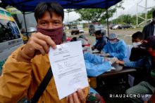 Seorang warga menunjukkan hasil rapid test saat bakti sosial dalam rangka HUT Bhayangkara 74. (Foto. Amri)