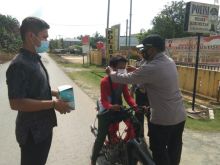 Cegah Penyebaran Covid-19, Bhabinkamtibmas Polsek Kerumutan Bagikan Masker