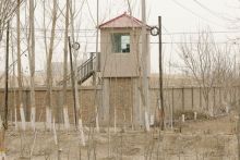 A security person watches from a guard tower around a detention facility in Yarkent county in northwestern China's Xinjiang Uyghur Autonomous Region, March 21, 2021. (AP Photo) 