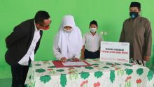 Ketua Yayasan AHM Ahmad Muhibbudin didampingi Ketua Yayasan Manbaul Quran Ade Akfan Miladi LC, M.A melakukan penandatanganan dan serah terima beasiswa. (Foto: Istimewa)