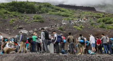 Foto yang diabadikan pada 31 Agustus 2023 ini menunjukkan pengunjung mendaki lereng Gunung Fuji, puncak tertinggi Jepang dengan ketinggian 3.776 meter (12.388 kaki). Dengan jutaan pengunjung setiap tahun dan bus, truk pasokan, toko mie dan magnet kulkas, Gunung Fuji tidak lagi menjadi situs ziarah y
